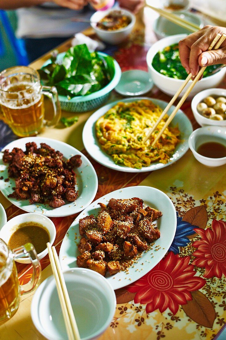 A Vietnamese meal featuring fried mountain goat and omelette