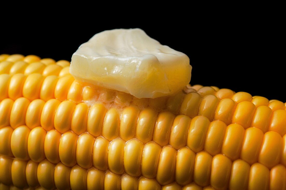 A hot corn cob with melting butter