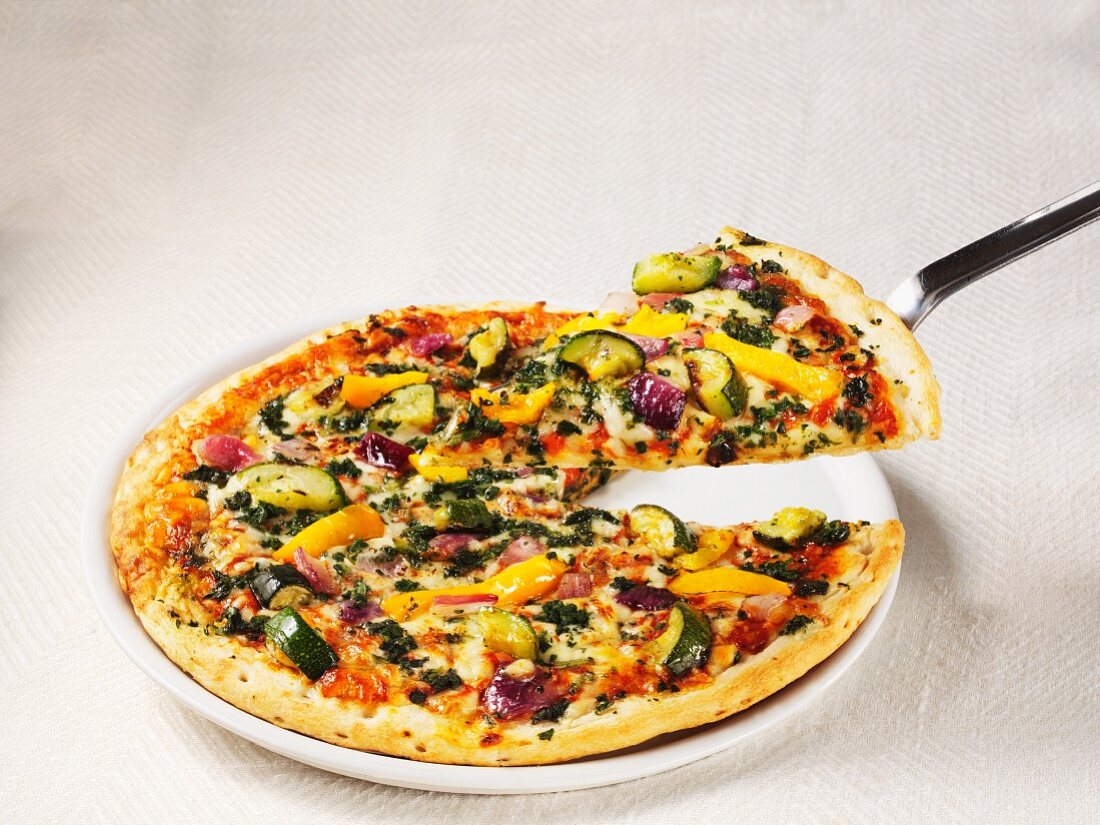 A pizza topped with Mediterranean vegetables