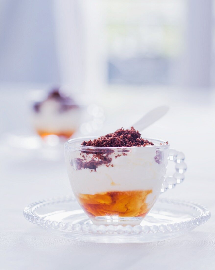 A verrine with cream, maple syrup and cocoa powder