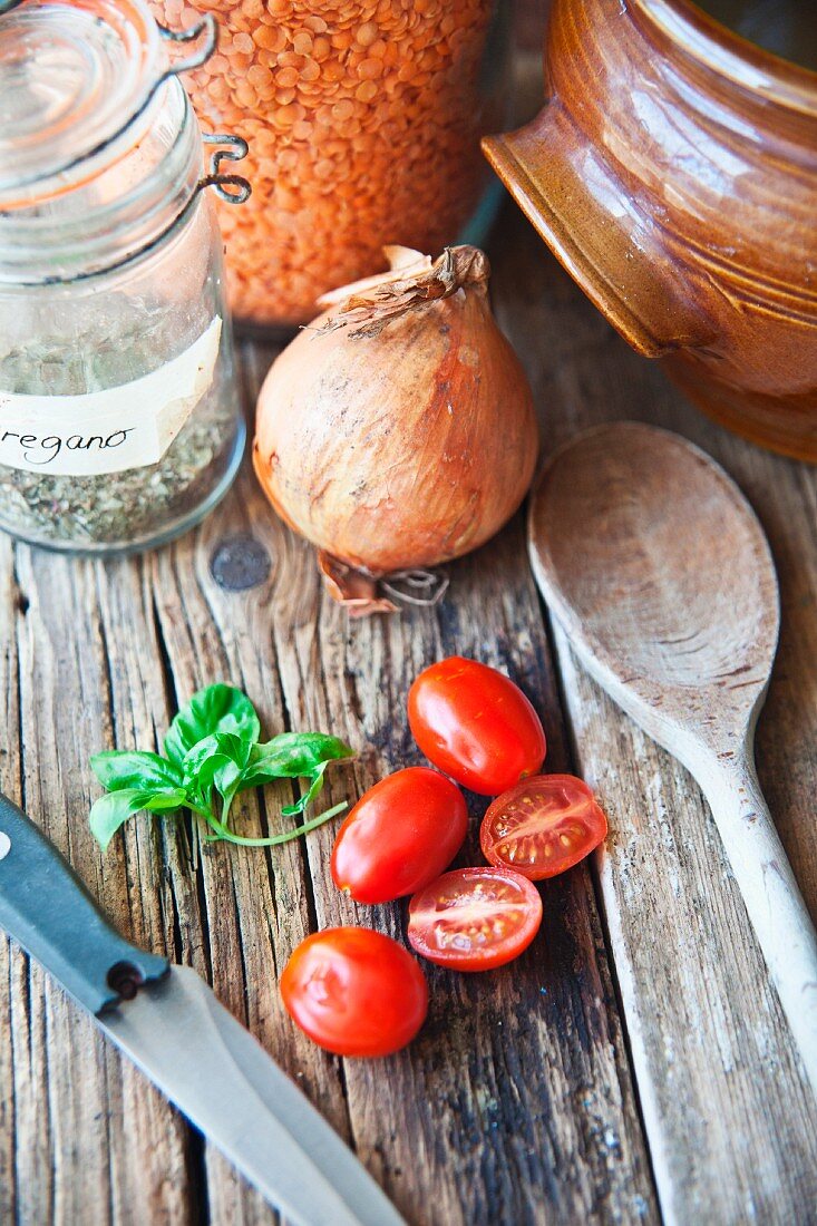 An arrangement of lentils, herbs and tomatoes