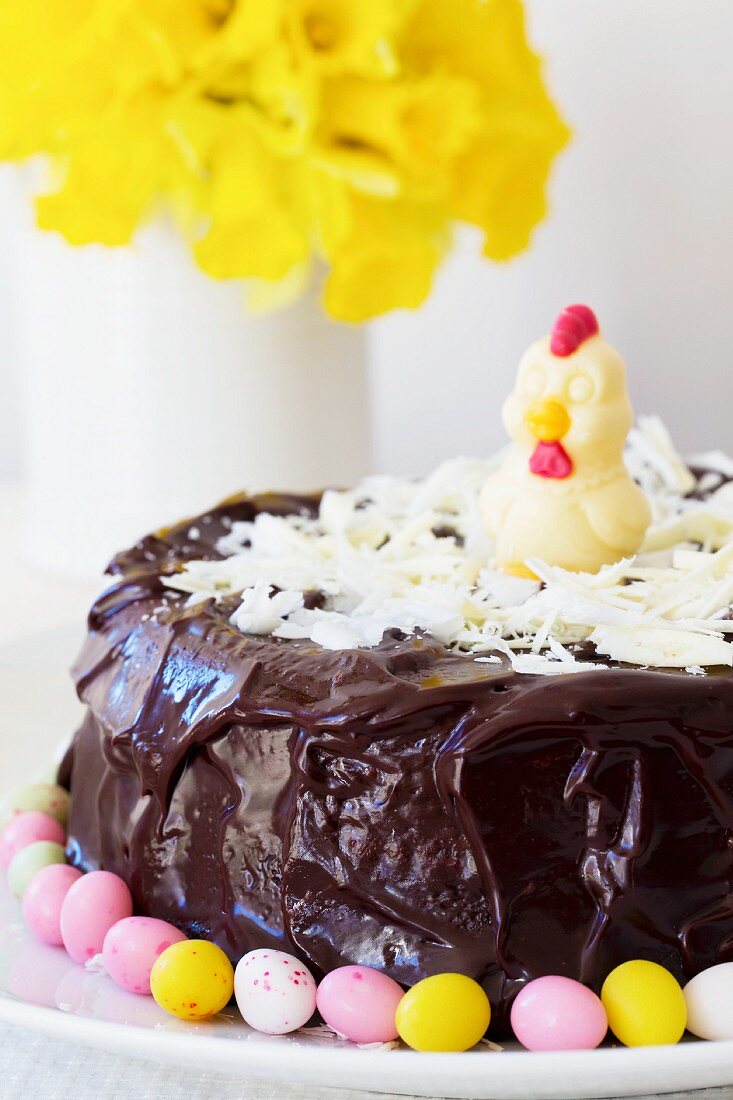 A cheerful Easter cake decorated with dark and white chocolate