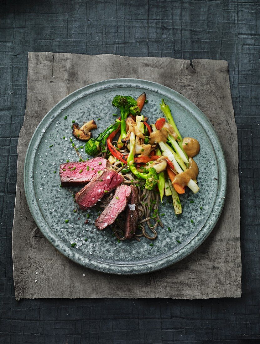 Strip steak with ramen noodles and vegetables