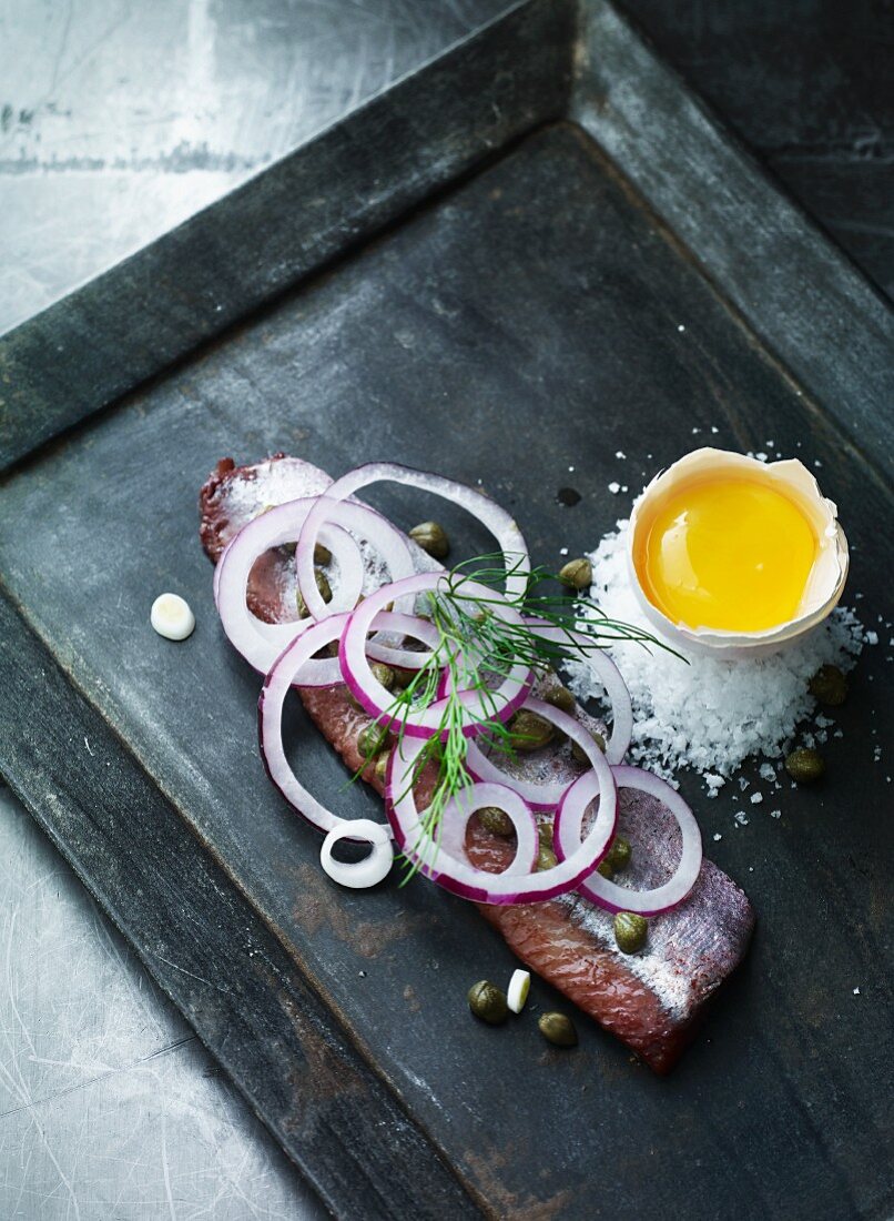 Herring fillets with capers, red onions and egg yolk