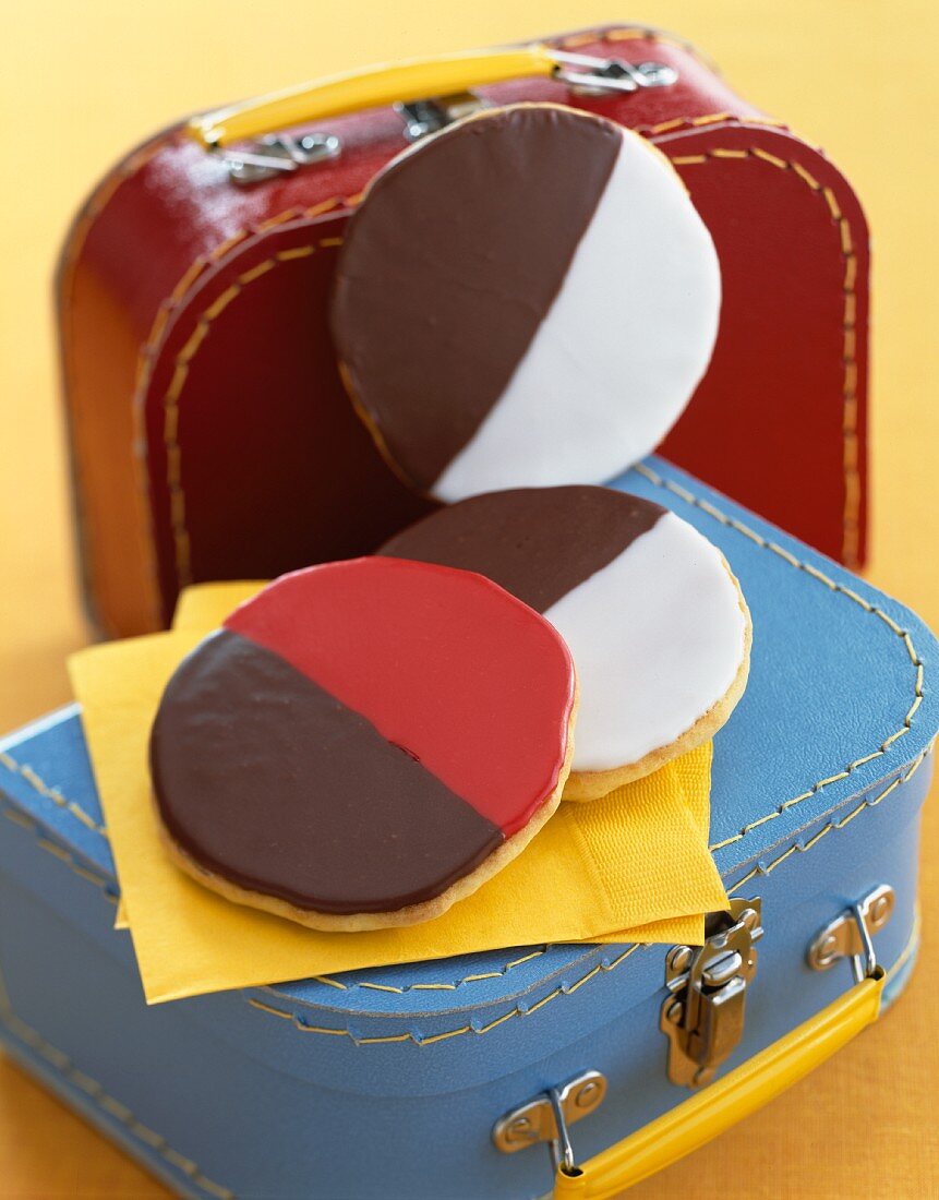 Black and white cookies on small suitcases
