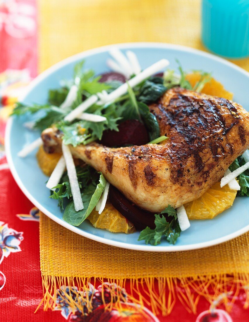 Roast chicken leg on an orange salad with beetroot