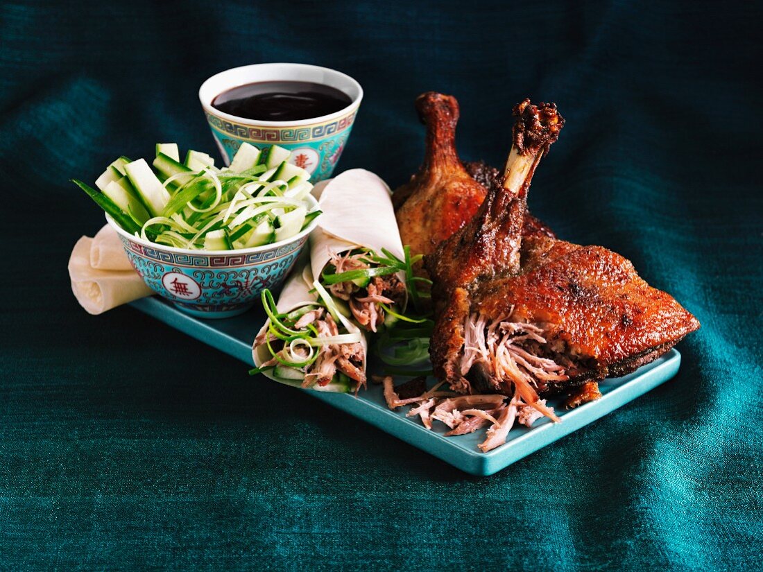 Crispy Peking duck and duck wraps with a cucumber salad and a soy sauce dip