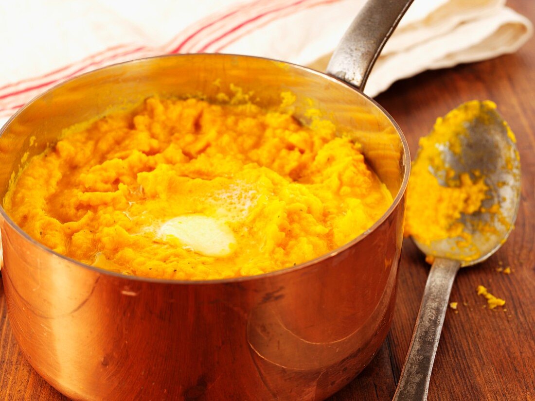 Carrot puree with butter in a copper saucepan