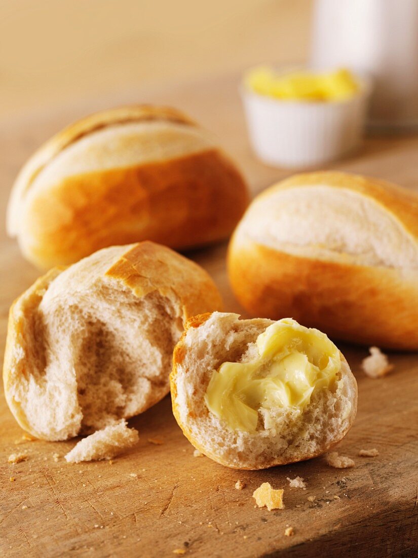 French baguette rolls, one spread with butter