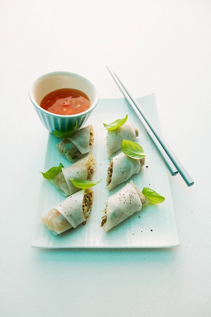 Rice paper rolls filled with minced meat and served with a chilli dip