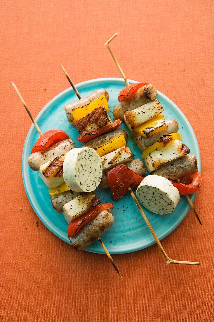 Grilled haloumi skewers with sausages, pepper and herb butter