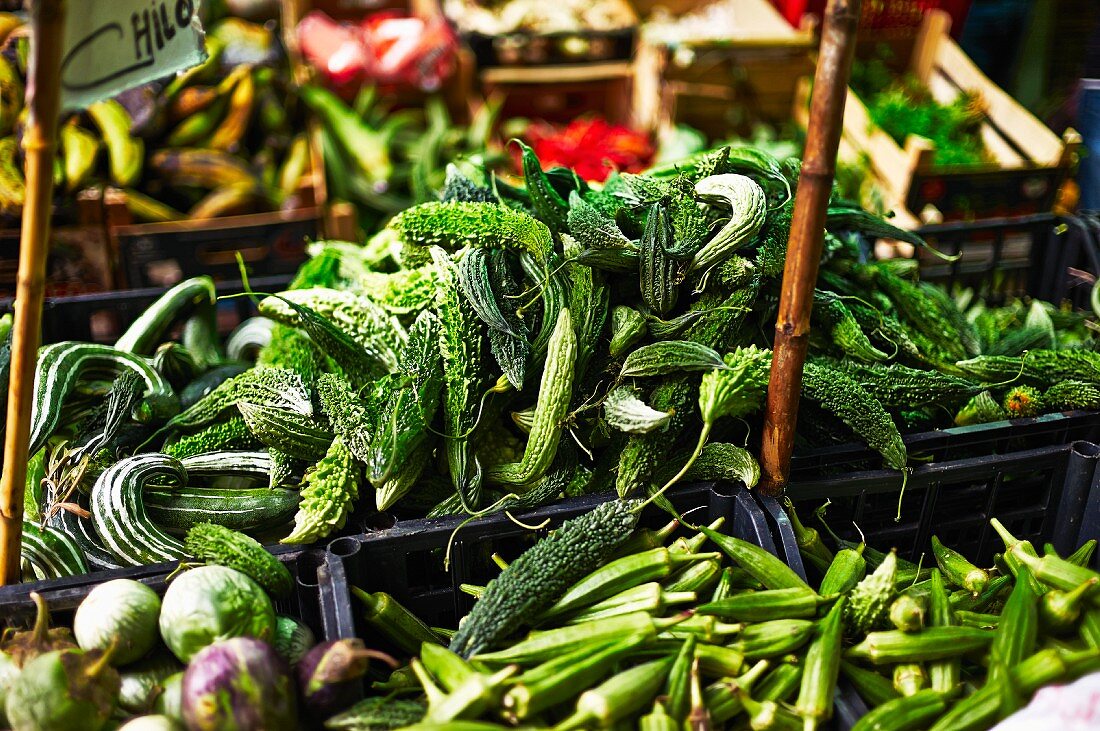 Bitter gourds and okra pods at a market (Italy)