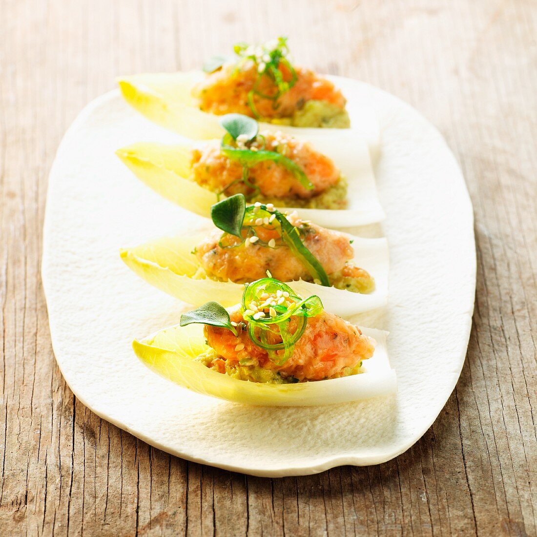 Chicory boats with guacamole, salmon salad and wakame