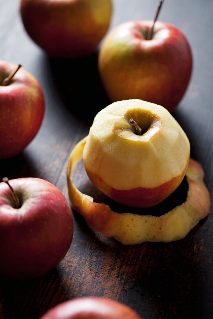 Apples, one partially peeled