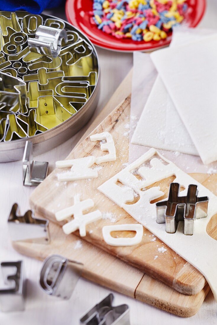 Letters cut out of puff pastry and alphabet pastry cutters