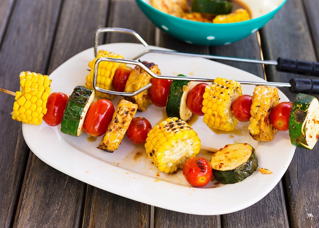 Vegetable skewers with tomatoes, corn and courgette