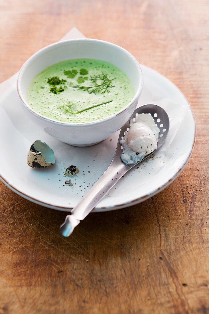 Cream of herb soup with poached quail's eggs