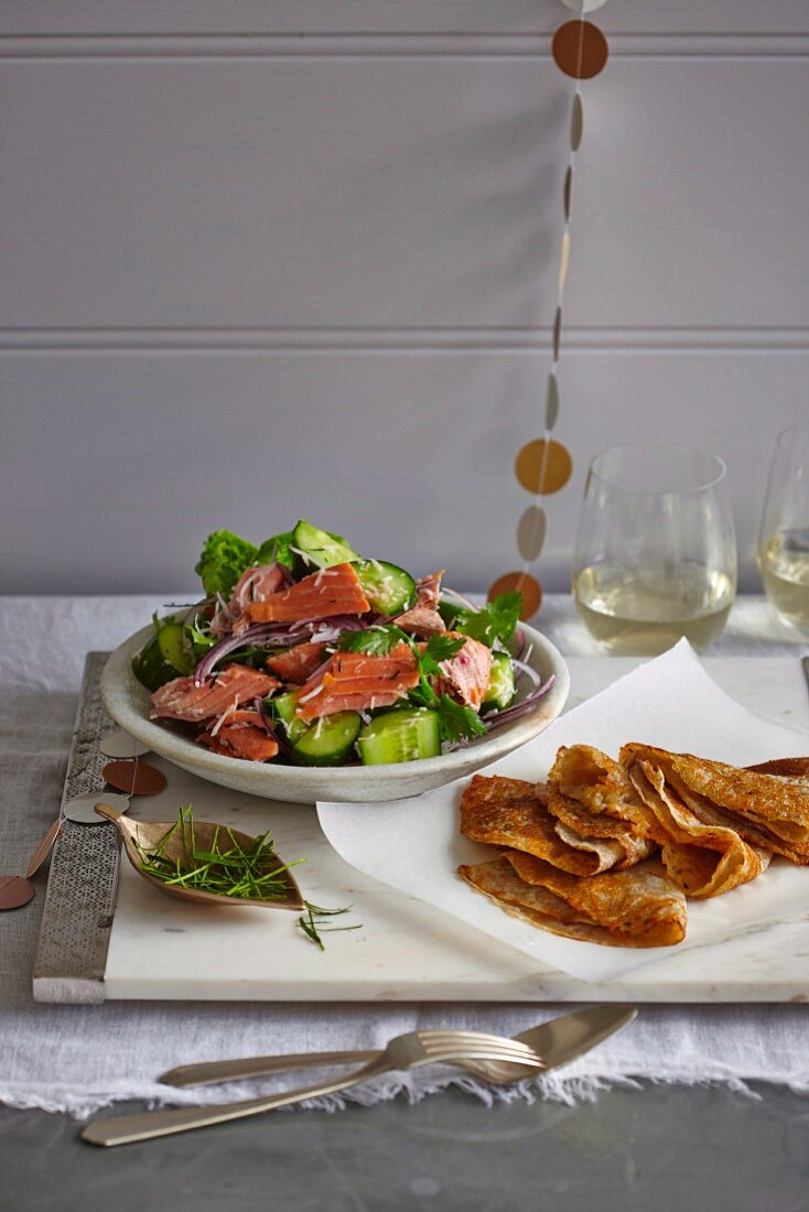 Cucumber and coconut salad with smoked trout and Indian pancakes