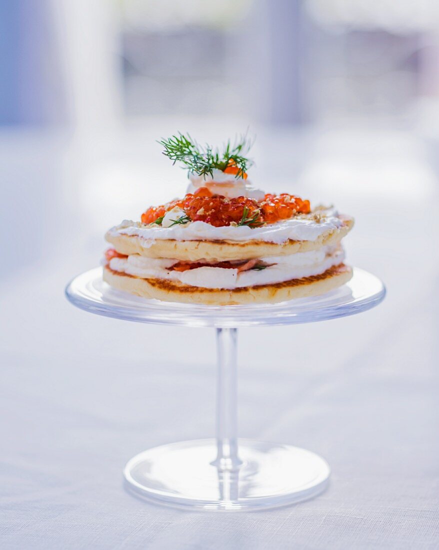 Pancake cake with creamy yogurt, salmon, salmon caviar and dill