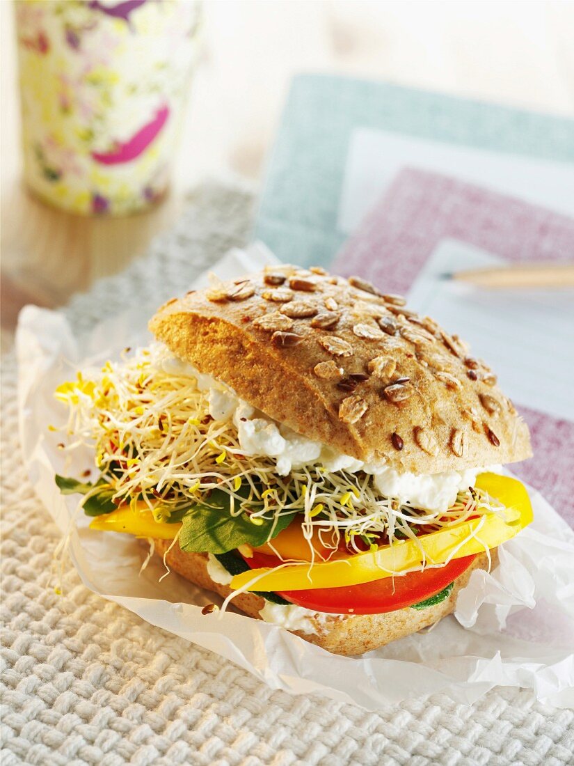 A veggie burger with peppers, bean sprouts and cottage cheese