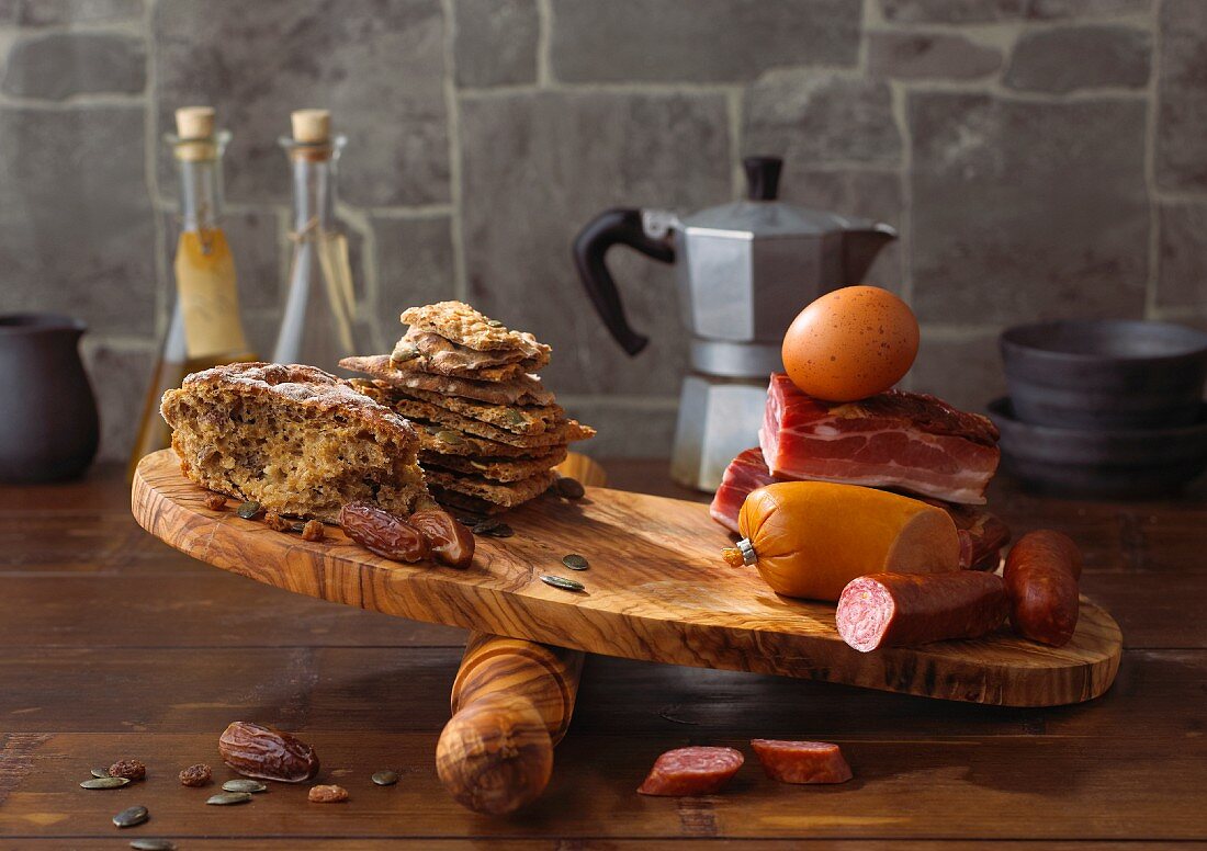 Bread, meat, eggs and sausage on a chopping board