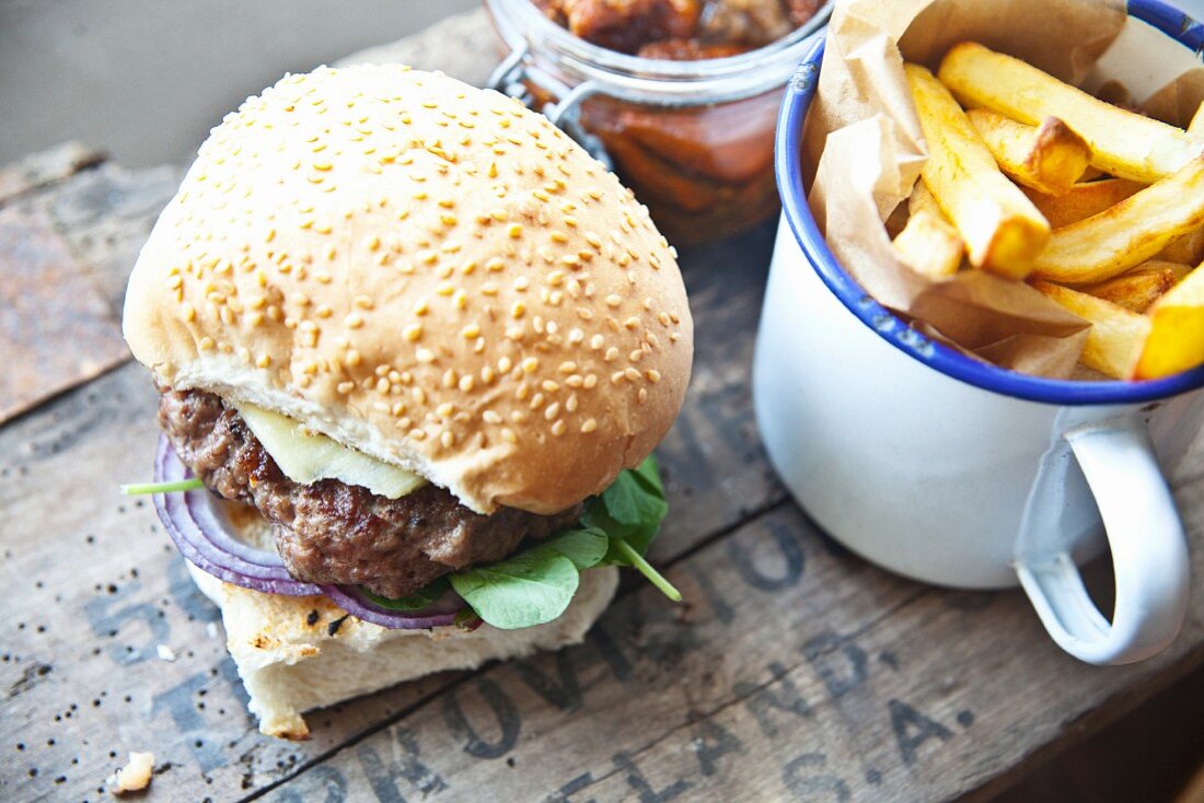 A homemade cheeseburger with watercress and chips