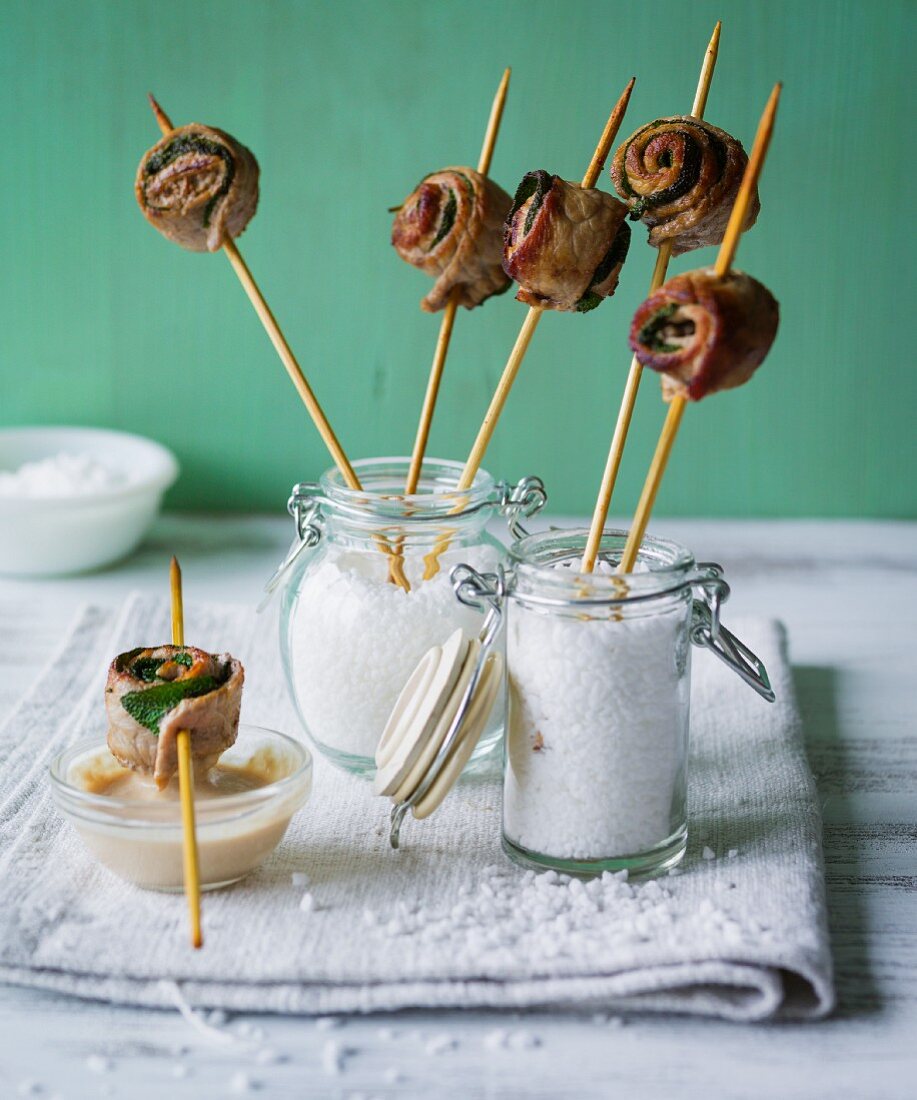 Veal rolls with sage on wooden sticks