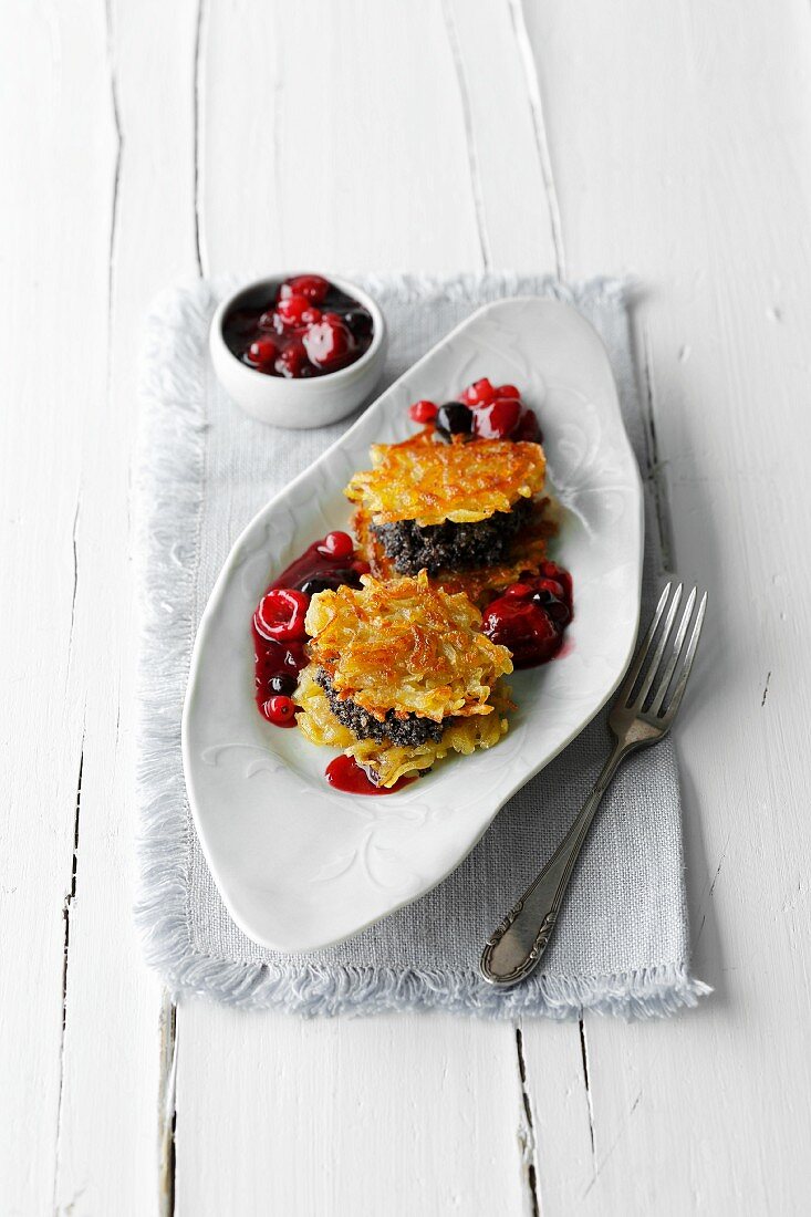 Potato and poppyseed cake with berry sauce