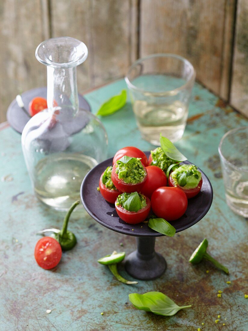 Avocado balls in hollowed out tomatoes with pimientos and pistiachios