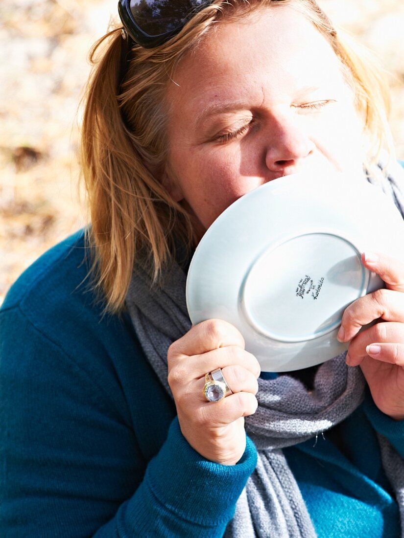 A woman licking a cake plate