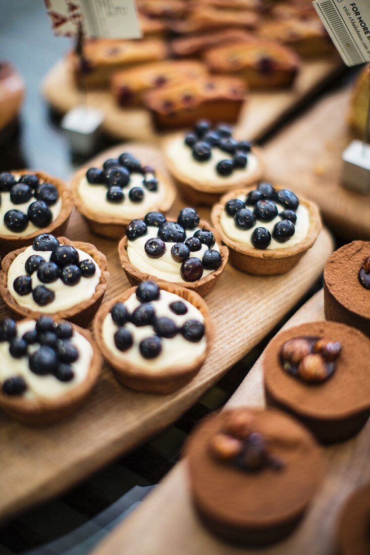 Blueberry tartlets, financiers and chocolate cakes in a bakery