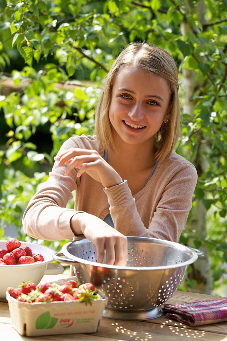 A girl with fresh strawberries