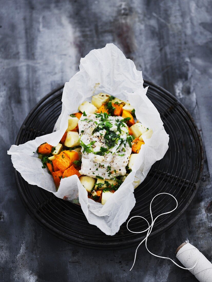 Flounder on root vegetables in parchment paper