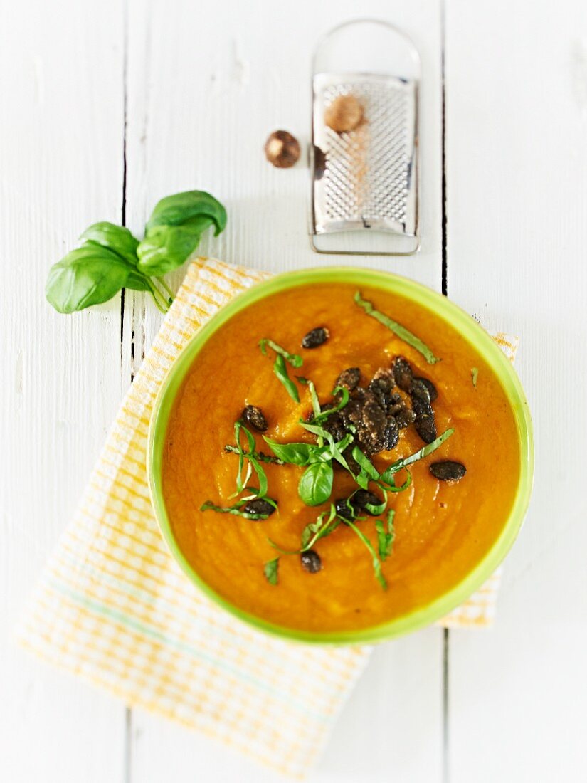 Pumpkin soup with caramelised pumpkin seeds and basil