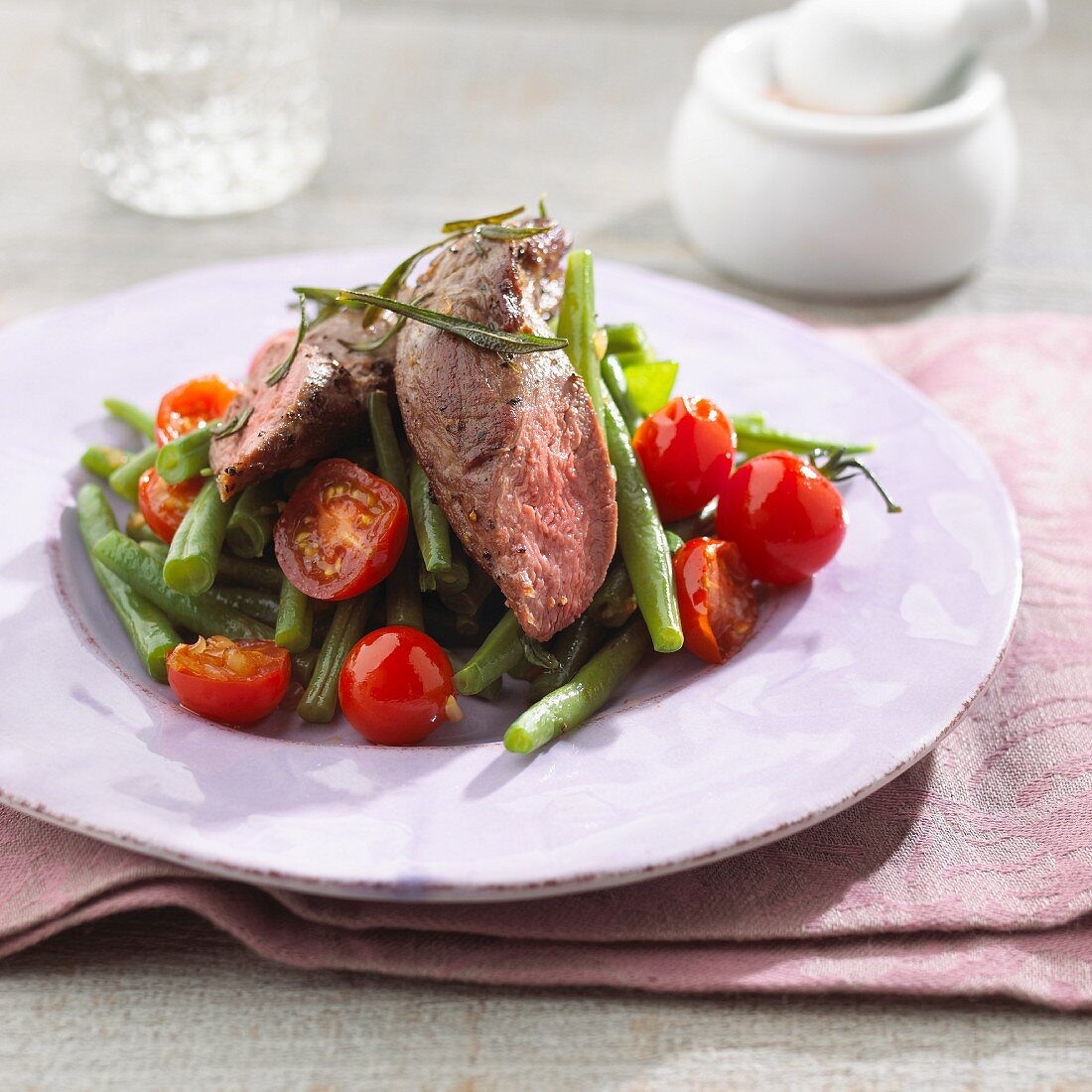 A bean and tomato medley with lamb fillet