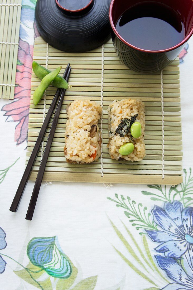 Sushi with soya beans on a bamboo mat with soy sauce (Japan)