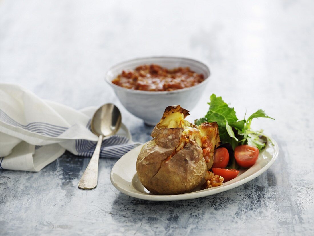 A baked potato with minced meat sauce