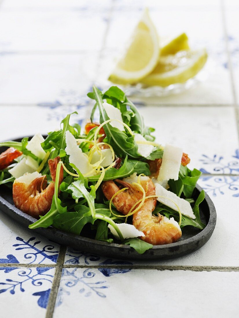 A rocket salad with prawns and Parmesan cheese