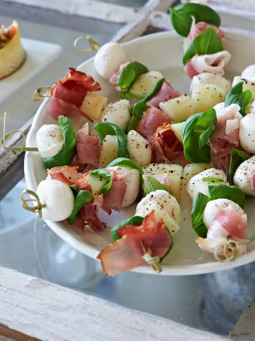 Ham and mozzarella skewers with basil