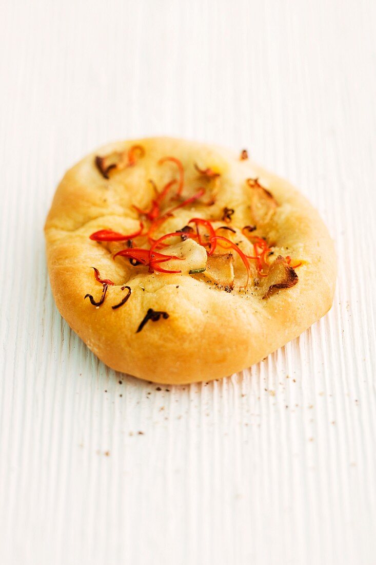 Focaccia with ginger and chilli on a wooden surface