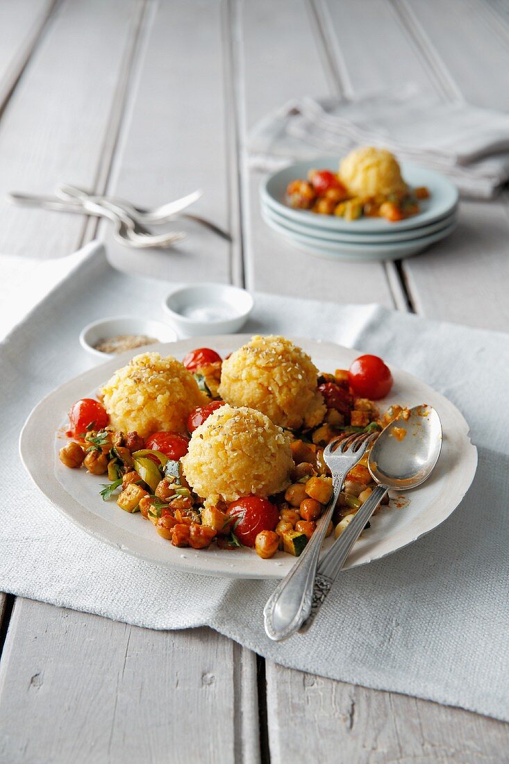 Sesame polenta on a bed of chickpeas and tomatoes