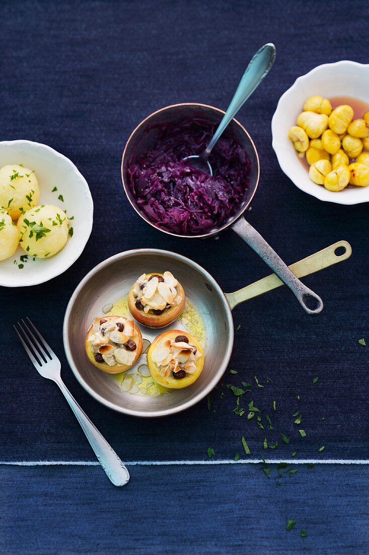 Various side dishes: potato dumplings, red cabbage, chestnuts, baked apples