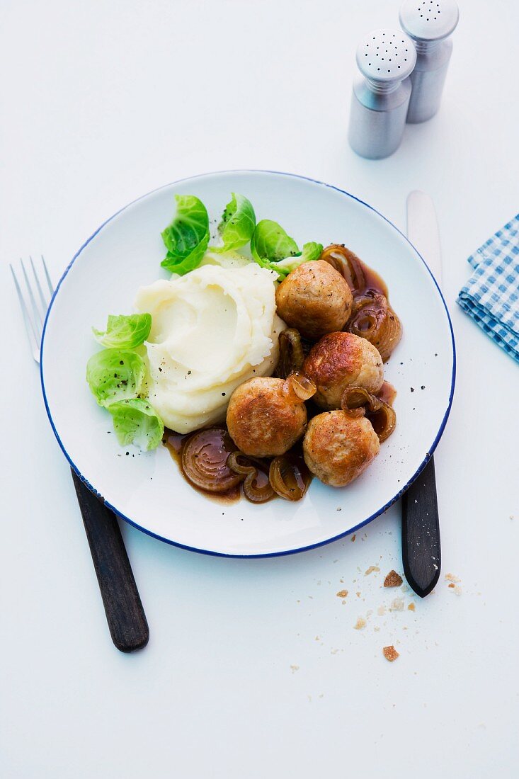 Chicken meatballs with mashed potatoes, onions and Brussels sprouts