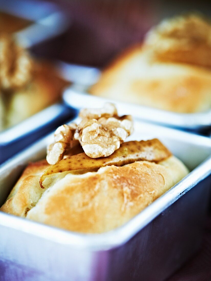 Pear and walnut bread in a baking tin