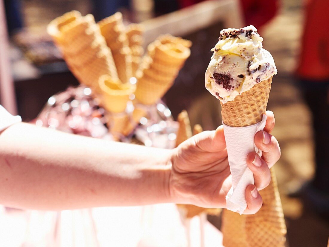 A hand holding an ice cream cone (market in Pretoria, South Africa)
