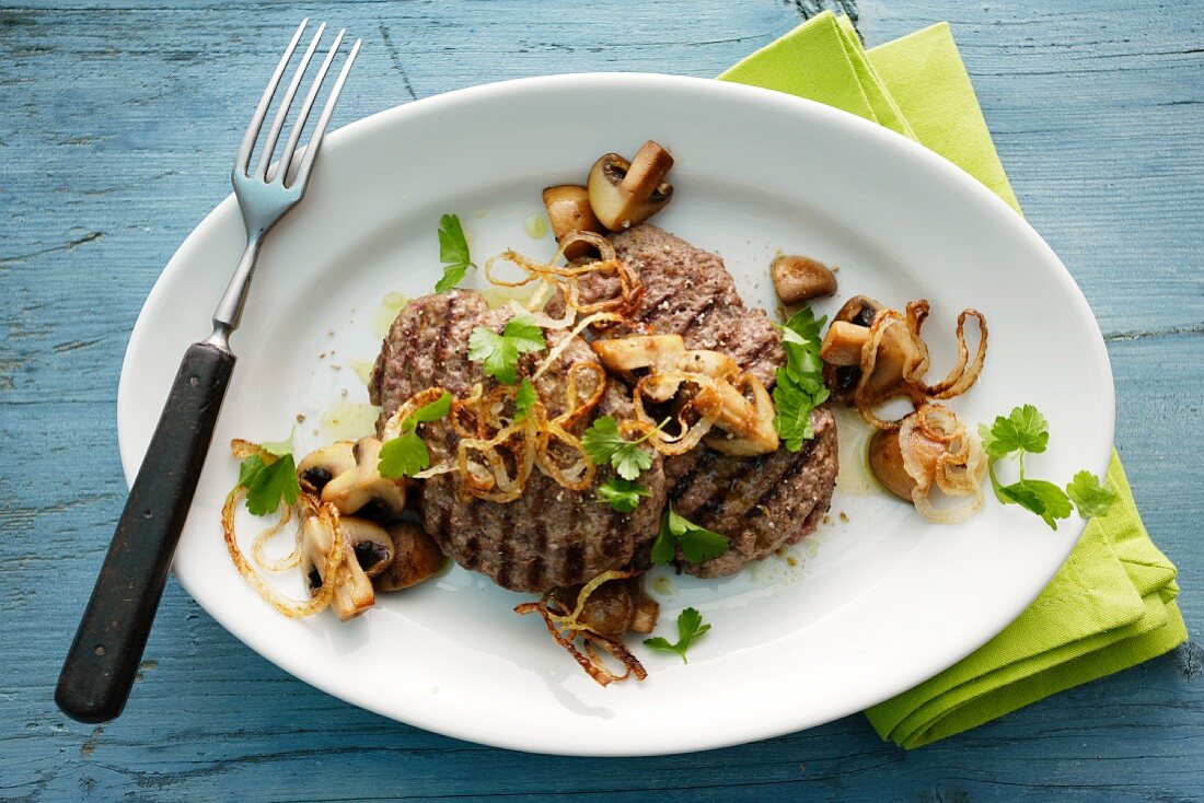 Minced meat steaks with onions and mushrooms