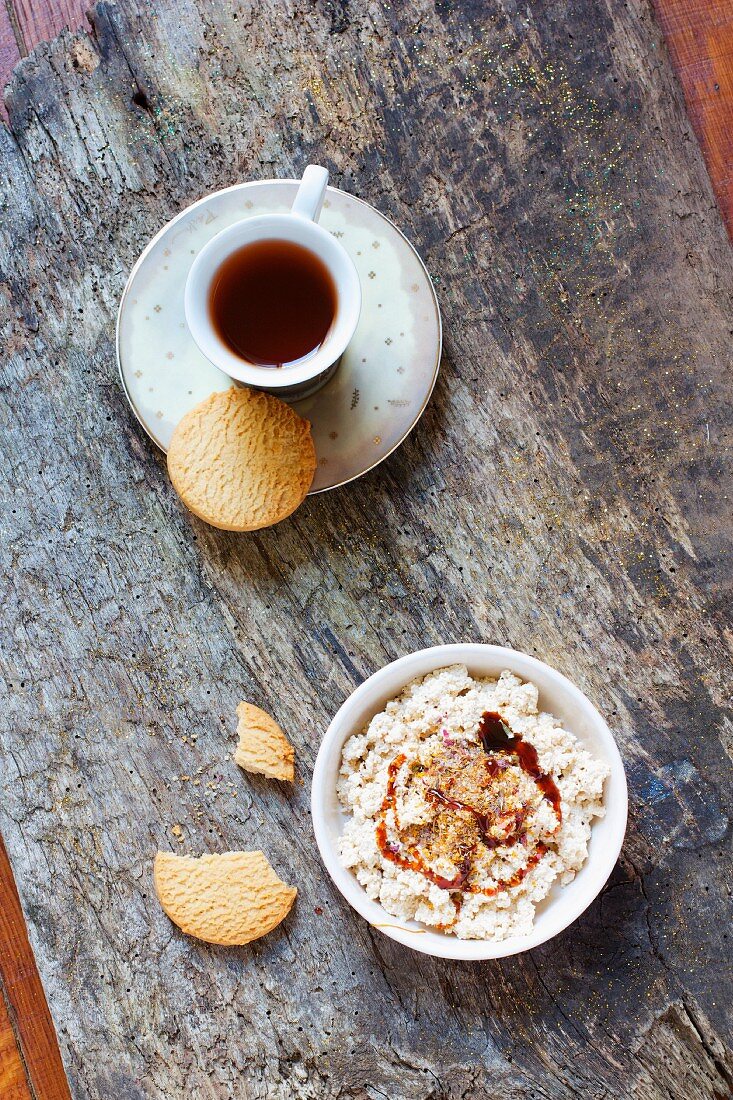 Homemade vegan cottage cheese made from soya milk with biscuits, flower powder and tea