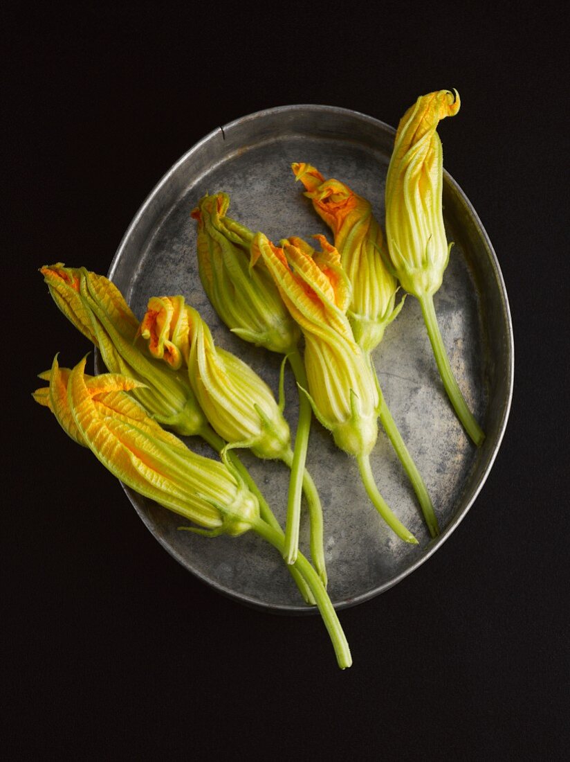 Courgette flowers on a metal tray