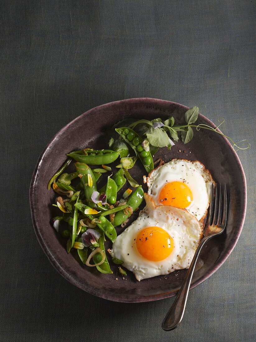 Fried eggs with a pea salad