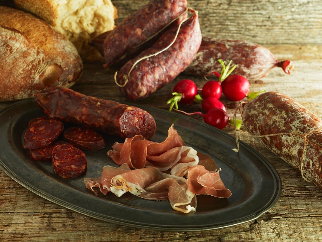 Salami, prosciutto, bread and radishes